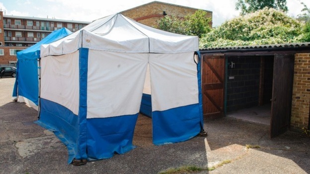 Body found in lock-up in a row of garages behind a quiet street