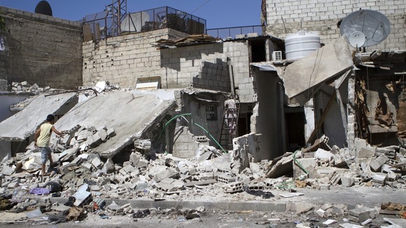 A Syrian child inspects his damaged house after further shelling in the Kadam district area near Damascus.