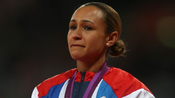Jessica Ennis listens to the national anthem on the podium with her gold medal.