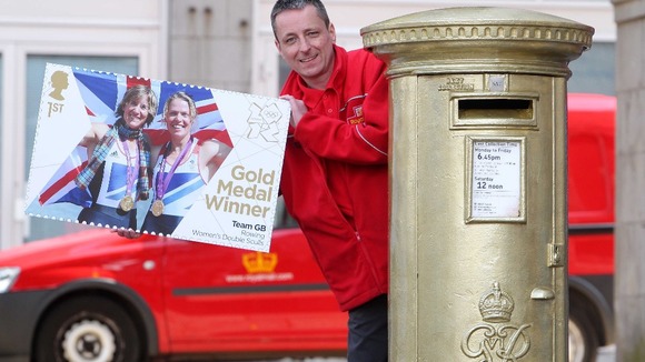 Postman Steve Allan at a golden post box to celebrate rower Katherine Grainger's gold medal in Aberdeen.