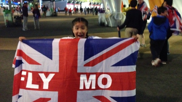 Farah's daughter Rihanna holds up a Team GB flag with pride and celebrates.