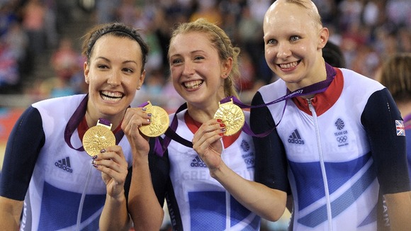 Britain's Dani King, left, Laura Trott, center, and Joanna Rowsell right, show their gold medals in the track cycling women's pursuit team.