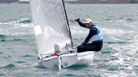 Great Britain's Ben Ainslie celebrates winning the Gold Medal after the Men's Finn Medal Race in Weymouth.