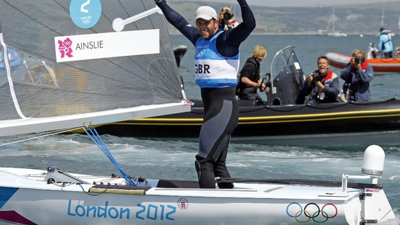 Britain's Ben Ainslie celebrates as he crosses the finish line to win the Finn class at the London 2012 Olympic Games.