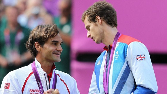 Murray embraces with Federer on the medal podium.
