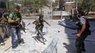 A Free Syrian Army fighter runs for cover during clashes with Syrian Army soldiers in the Salah al- Din neighbourhood of central Aleppo.