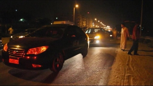 Cars wait as the highway to the checkpoint is closed