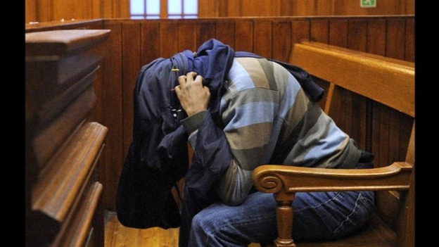Mziwamadoda Qwabe hides his face at today's hearing