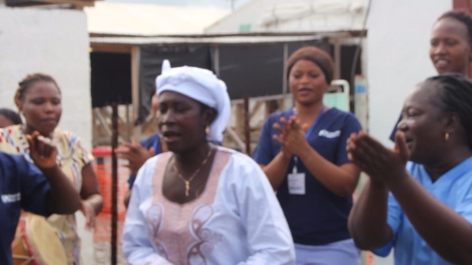 Medical staff clap as Ms Sankoh, thought to be the last survivor of Ebola, leaves the treatment centre