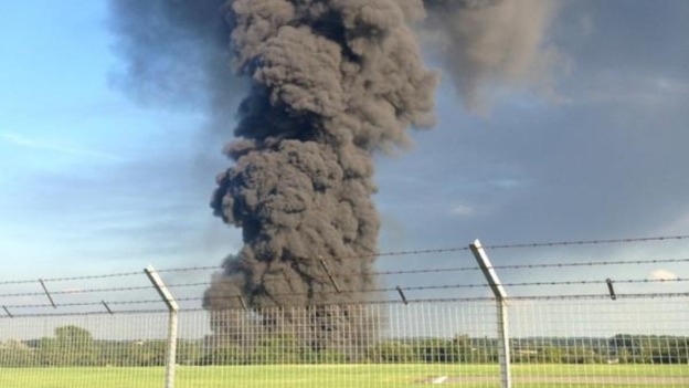 Plumes of smoke fill the skies from warehouse fire