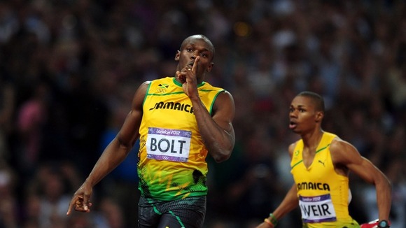 Bolt cruises past the finishing line.