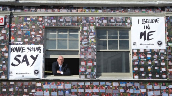 Trevor Reeves, one of the owners of House of Reeves furniture shop, looks through the window of his shop in Croydon, south London.