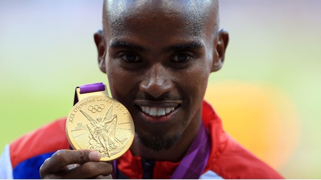 Great Britain's Mo Farah receives his gold medal for the men's 10,000m final 