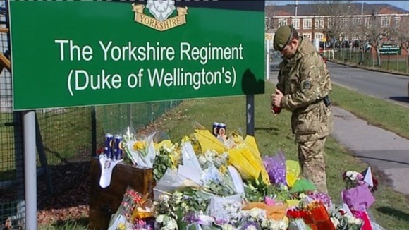 Flowers at the base of Yorkshire regiment barracks