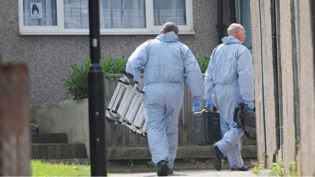 Forensic police officers leave the home of Christine Sharp, grandmother of missing school girl Tia Sharp