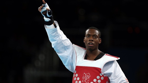 Great Britain's Lutalo Muhammad celebrates after winning bronze against Armenia's Arman Yeremyan.
