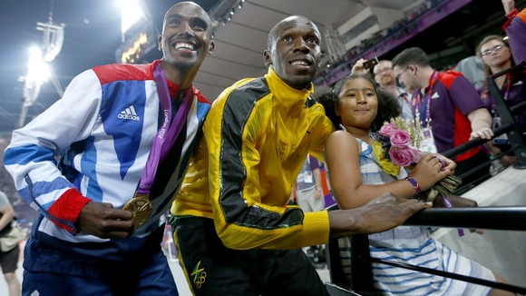 Jamaica's Bolt celebrates with Britain's Farah and Farah's daughter, Rhianna.