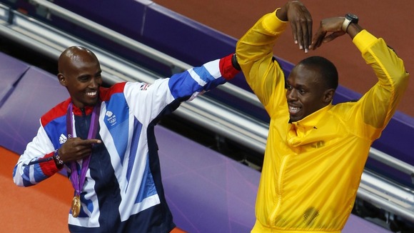 Farah and Bolt embrace.