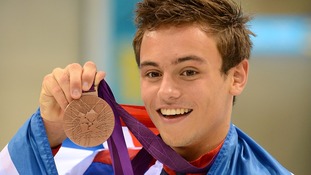 Tom Daley shows off his medal