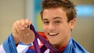 Tom Daley shows off his medal