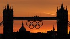 Sun sets behind the Olympic rings on Tower Bridge