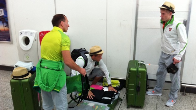 Athletes check their luggage before heading home