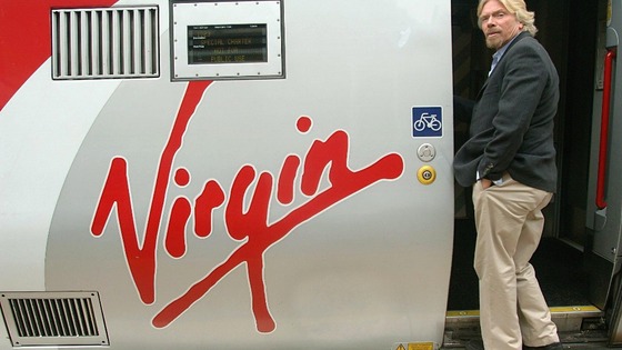 Sir Richard Branson boarding a Virgin train.