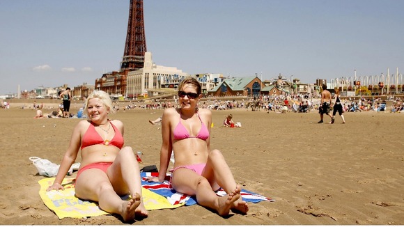 Two beach-goers enjoying the sun in Blackpool