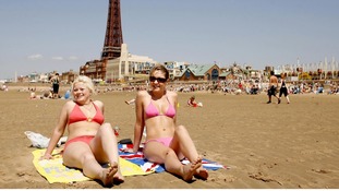 Two beach-goers enjoying the sun in Blackpool