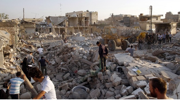 Men search for bodies of people killed during a recent Syrian Air Force air strike in Azaz