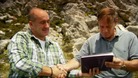 Nick Taylor gives Marcello Llambias a photo album containing the photographs he took in 1982
