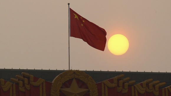 The national flag flies from the top of the National Museum of China.