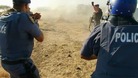 Police fire at striking miners outside a South African mine owned by Lonmin's of London 