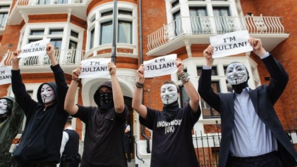 Masked supporters of Julian Assange outside the Embassy of Ecuador in Knightsbridge.