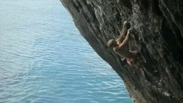 Neil Gresham scales the cliff face in Pembrokeshire.