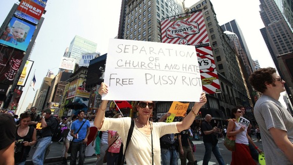 Protesters hold signs and march through Times Square while demonstrating in solidarity with the Russian punk band Pussy Riot in New York