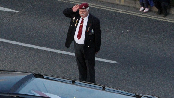 A retired solider salutes the dead soldiers