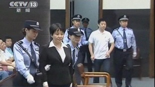 Gu Kailai and her former aide Zhang Xiaojun are escorted into the courtroom
