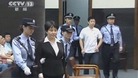 Gu Kailai and her former aide Zhang Xiaojun are escorted into the courtroom