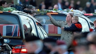 Relatives and friends laid flowers on the cortege