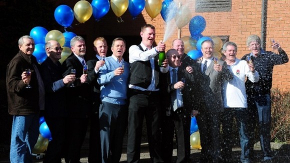 The syndicate of bus drivers who won £38 million in the EuroMillions celebrate with champagne.