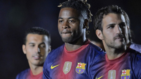 Alex Song (centre) with Cesc Fabregas (right).