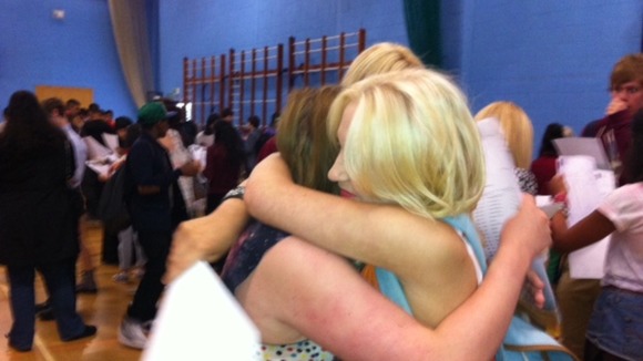 Students embrace as they receive their results