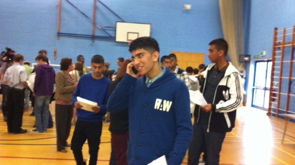One pupil tells relative his results on the telephone