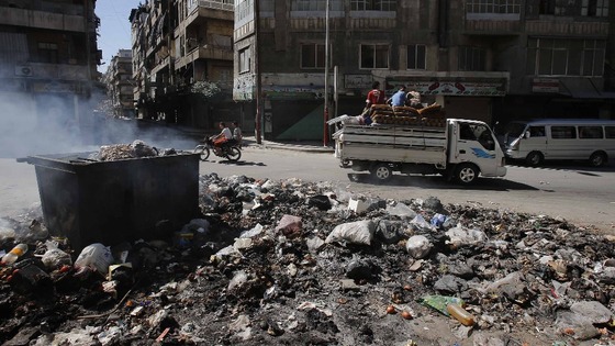 Smoke clears after residents burn rubbish in Aleppo's streets