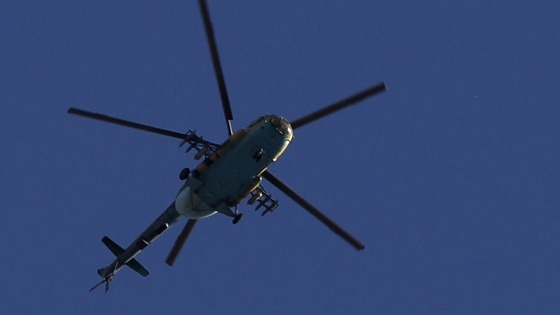 A Syrian Air Force helicopter prepares to fire a rocket in Aleppo city