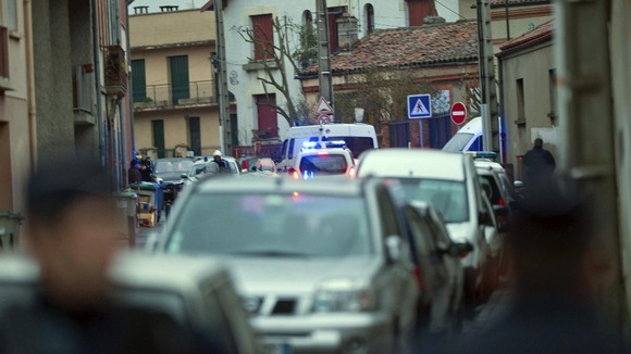 French police secure the area where they exchanged fire and were negotiating with a gunman in Toulouse