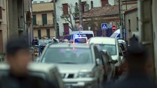 French police secure the area where they exchanged fire and were negotiating with a gunman in Toulouse