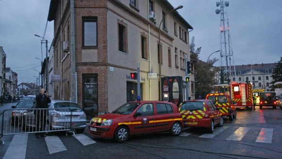 Firefighter ambulances are parked at the entrance of a street in Toulouse