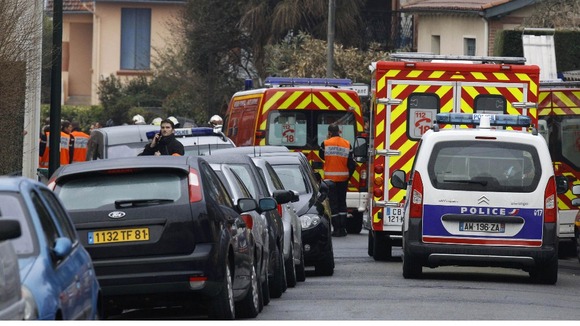 Ambulances and police vehicles are parked in the street of Toulouse